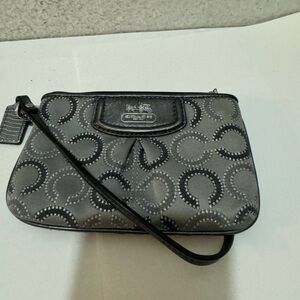 Black and gray authentic Coach wristlet with zipper.